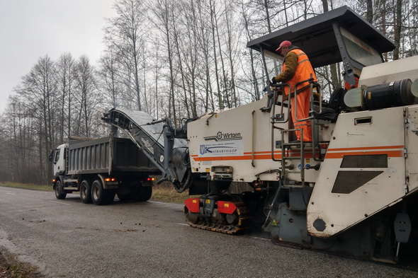 Large milling machine for removing of asphalt Wirtgen W 210 and Renault Kerax 380 dump truck. Complete pavement removal